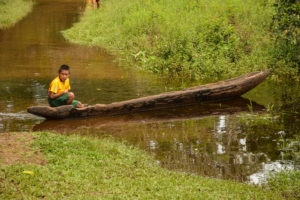 Just waiting: A young boy sits in a dugout near Chenapau in Region Eight. (Photo by Mariah Lall)