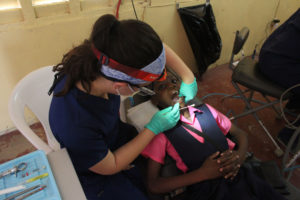 A child undergoes a dental procedure during the outreach