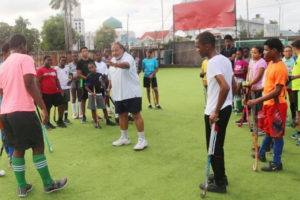International Hockey Federation (FIH) Coach Shiv Jagday makes a point to the junior players during one of his coaching sessions at the Georgetown Cricket Club (GCC) ground
