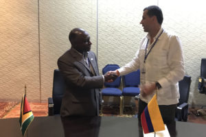 Guyana’s Foreign Minister Carl Greenidge (left) and a Colombian official shaking hands on the deal. (Ministry of Foreign Affairs photo)