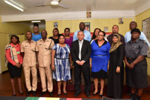 Minister of Social Cohesion, Dr. George Norton (fourth from right) is flanked by members of the New Amsterdam Harmony group, representatives from the Guyana Police Force, the Guyana Fire Service, representatives from the Ministry of Social Cohesion and members of the Regional Administration. (Ministry of the Presidency photo)