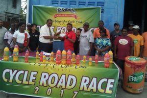 Robert Selman, General Manager of the Guyana Beverage Company, hands over the sponsorship to second vice-president of the FACC Neil Reece while organiser and Coach Randolph Roberts and others look on.