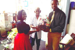 The Linden Mayor & Town Council yesterday presented hampers to a few elderly men in Linden. In this photo, Deputy Mayor Waneka Arrindell (left) makes the presentation on behalf of the council in the presence of Mayor Carwyn Holland to 96-year-old Herman Haynes of Christianburg. Haynes served as a councillor of the municipality under Mayor Egbert Benjamin between the years 1971-1975.