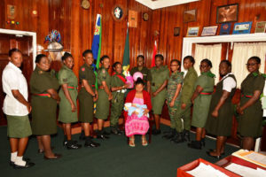 Female ranks of the GDF flank Susan Wilson, as she cradles her newborn baby girl during a courtesy call on the Chief of Staff Brigadier Patrick West  (Guyana Defence Force Photo)