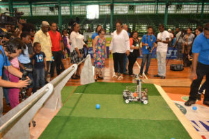 First Lady Sandra Granger (left) and Co-Founder of STEM-Guyana Karen Abrams observing a demonstration by one of the participating teams.  