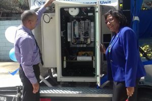 Minister of Public Telecommunications Catherine Hughes (right) and Director of the National Frequency Management Unit (NFMU) Valmikki Singh at the commissioning of the three frequency monitoring stations yesterday. Pictured above is the transportable station.