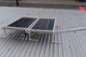 Two solar panels on top of the roof of Ajay Bhyro’s store in Bartica. 
