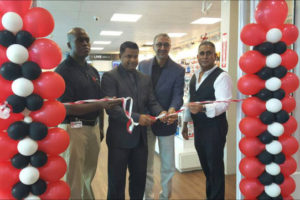 Managing Director of Unicomer Group, Clyde de Haas (second from right) being assisted by the President of Giftland Mall, Roy Beepat (right), Deodat Indar (second from left) and the store’s manager, Rondell Bristol for the ceremonial cutting of the ribbon to declare the store open