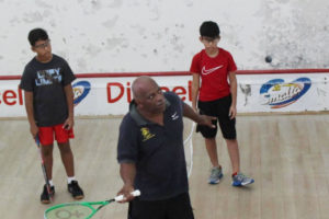 Coach Carl Ince going through the paces with a few of nation under-11 squash players at the Georgetown Club Squash Court, yesterday morning. (Royston Alkins photo)