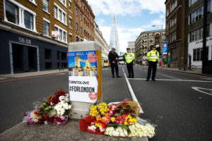 Flowers and messages lie behind police cordon tape near Borough Market after an attack left 7 people dead and dozens injured in London, Britain, June 4, 2017. REUTERS/Peter Nicholls 