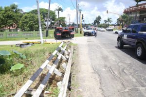 After taking out the rail of the bridge at the corner of Mandela and Homestretch avenues and knocking down the traffic light pole, this truck, GEE 7682, with ‘For Hire 654-8322’ painted on its side, ended up nose down in the drain outside President David Granger’s home yesterday morning. (Photo by Keno George)