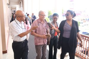 Former Minister of Education Dr Rupert Roopnaraine (second from left) speaking yesterday to reporters in the corridor of Parliament about his reassignment to the Ministry of the Presidency. 