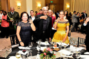 President David Granger (centre) is flanked by First Lady,  Sandra Granger (left)  and their daughter,  Han Granger-Gaskin as they raised their glasses to toast THAG’s 25th anniversary. (Ministry of the Presidency photo)