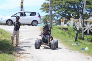 Go-karting: Boys having fun on a makeshift go-kart at Triumph, East Coast Demerara
yesterday (Photo by Keno George) 