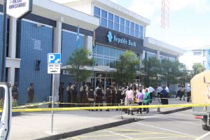 Members of the Professional Guard Service, bank employees and police ranks gathered in front the Water Street location where the attack occurred.