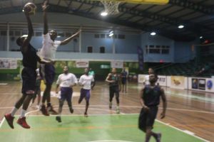 “Not in my house” Akeem Crandon (centre) of President’s College attempts a block against a St. Roses High player, during their U19 fixture at the Cliff Anderson Sports Hall, Homestretch Avenue