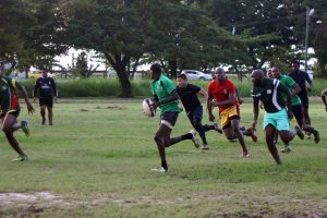The Green Machine practicing yesterday in the swampy National Park rugby field. Despite the recent inclement weather, the spirit of the national rugby squad is far from dampened. (Orlando Charles photo)