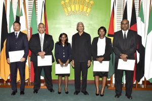 From left are Gino Persaud, Sandil Kissoon, Simone Morris-Ramlall, President David Granger, Damone Younge and Justice Deo Rishi Persaud after the swearing-in ceremony at State House yesterday. (Ministry of the Presidency photo)