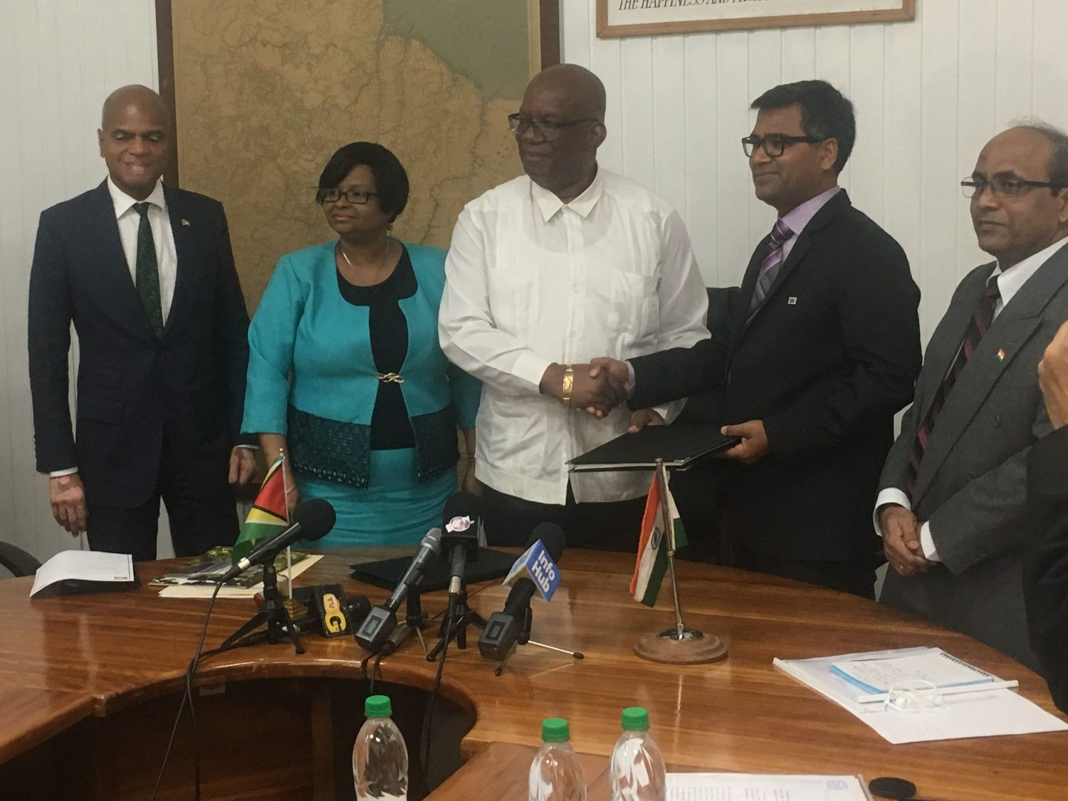 Minister of Finance, Winston Jordan (centre) shaking hands with Exim Bank of India’s Resident Representative Sailesh Prasad, after signing the line of credit agreement. Also present are Guyana’s High Commissioner to India, Dr. David Pollard (left), Minister of Public Health, Volda Lawrence (second from left) and India’s High Commissioner to Guyana,  V. Mahalingam.
