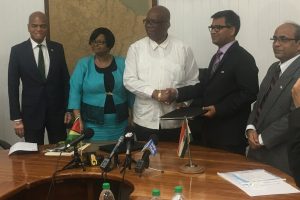 Minister of Finance, Winston Jordan (centre) shaking hands with Exim Bank of India’s Resident Representative Sailesh Prasad, after signing the line of credit agreement. Also present are Guyana’s High Commissioner to India, Dr. David Pollard (left), Minister of Public Health, Volda Lawrence (second from left) and India’s High Commissioner to Guyana,  V. Mahalingam.
