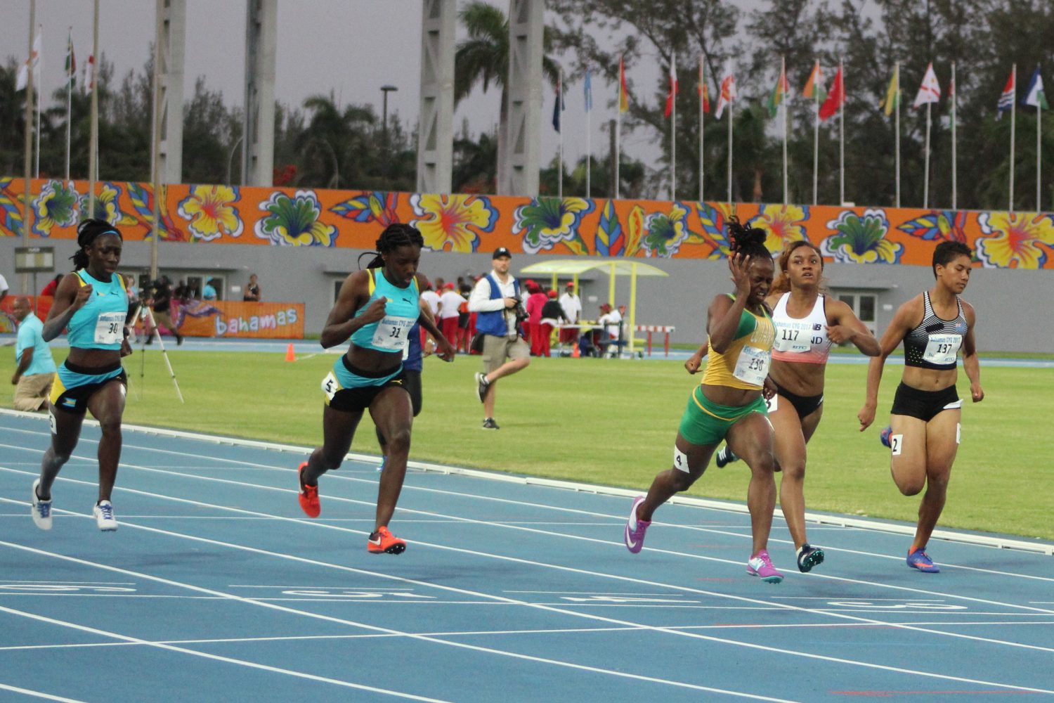 Guyana’s Onassah Rogers (right) storming to victory in the under-18 Girls  100m semi-final  (Royston Alkins Photo)