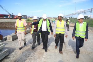 Executives of GSBI giving Minister of Natural Resources, Raphael Trotman (centre) a tour of the facility.