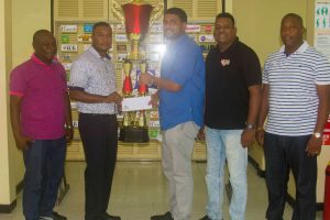  Rawle Nedd (Banks Beer Trainer Manager) (second left) presents the sponsorship package to Nasrudeen Junior Mohamed (Guyana Cup Promoter) while Troy Peters (Communications Manager , Roy Jafarally (Race Organiser)  and Mortimer Stewart (Outdoor Events Manager) look on.
