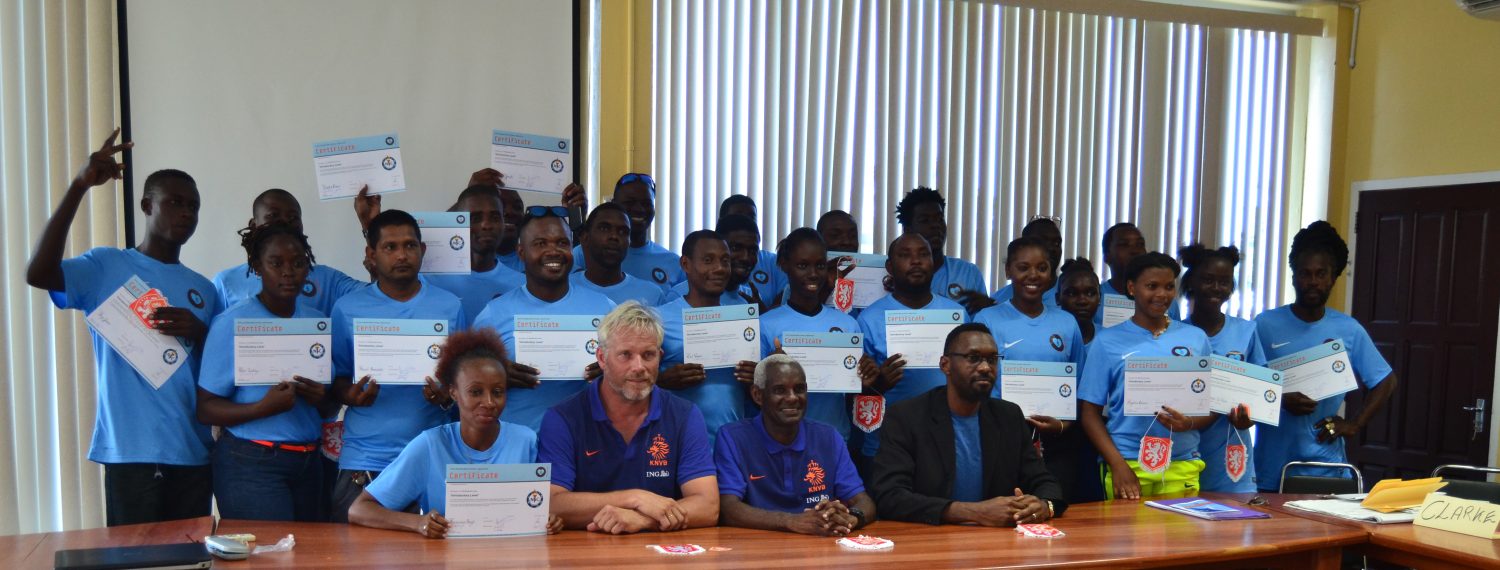 The successful participants of the National Sports Commission (NSC)/Royal Dutch Football Association (KNVB) five-day training course displaying their certificates in the presence of Sports Director Christopher Jones (sitting right), KNVB representative Andre Simmelink (sitting 2nd left) and Surinamese Football Coach Kenneth Jaliens