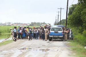 Police officers yesterday morning keeping persons from venturing near the Lusignan Prison compound where the inmates from the burnt out Camp Street Prison are being temporarily housed.