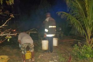 Firefighters using buckets to douse the small fires last night