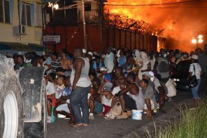 Prisoners on Camp Street waiting to be escorted to the Lusignan Prison on Sunday (Department of Public Information photo)