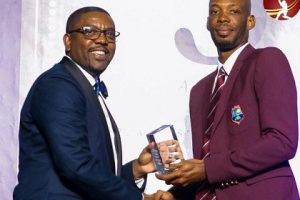 Roston Chase receives his Test Cricketer-of-the-Year award from Cricket West Indies president, Dave Cameron. (Photo courtesy West Indies Players Association) 