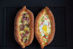  Khachapuri (Georgian Cheese Bread) with ham on the left and egg on the right. Photo by Cynthia Nelson