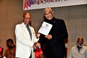 President David Granger (right)  presenting the Guyana Visual Art Competition’s Lifetime Achievement Award to Mr. Jorge Bowenforbes at the National Cultural Centre (Ministry of the Presidency photo)