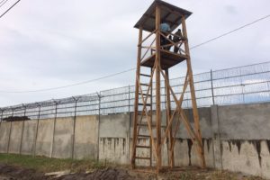 Ranks of the Guyana Police Force and the Guyana Defense Force mounted on one of the four new watchtowers erected to at the new holding facility constructed to house inmates at the Lusignan prison.