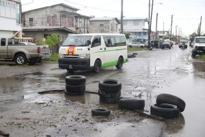Residents last week placed old tyres around a large pothole on Norton Street, Lodge in a bid to prevent vehicles from dropping in. It was related to Stabroek News on Thursday that the large pothole had been in such a state for more than a week. (Photo by Keno George) 