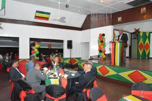 Some of the guests at the Berbice Chamber of Commerce’s fundraising dinner listen as Minister of State Joseph Harmon (at lectern) delivers his address (Ministry of the Presidency photo)