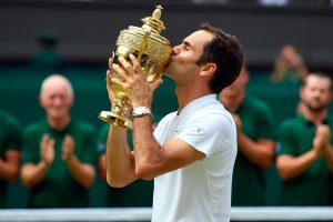 SWEET TASTE OF NUMBER EIGHT! Wimbledon men’s singles champion Roger Federer kisses the Wimbledon trophy.