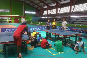 Former Caribbean men’s singles champion Sydney Christophe makes a point to the Pre- and Mini cadet players at yesterday’s training session at the National Gymnasium. At right is former national men’s singles champion Andrew Gorsira while national coach Linden Johnson is at centre. (Donald Duff photo)