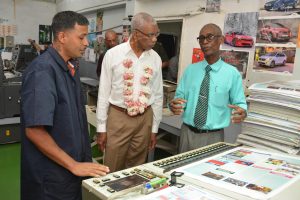 Manager, Derek Gaspar (right) explaining to President David Granger how one of the printing machines work (Ministry of the Presidency photo)
