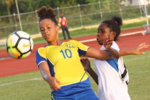  Caitlin Padmore (no.10) of Barbados trying to maintain control of the ball while being engaged by a Cuban player during their CONCACAF Girls U17 Qualifying Championship match at Leonora (Orlando Charles photo)
