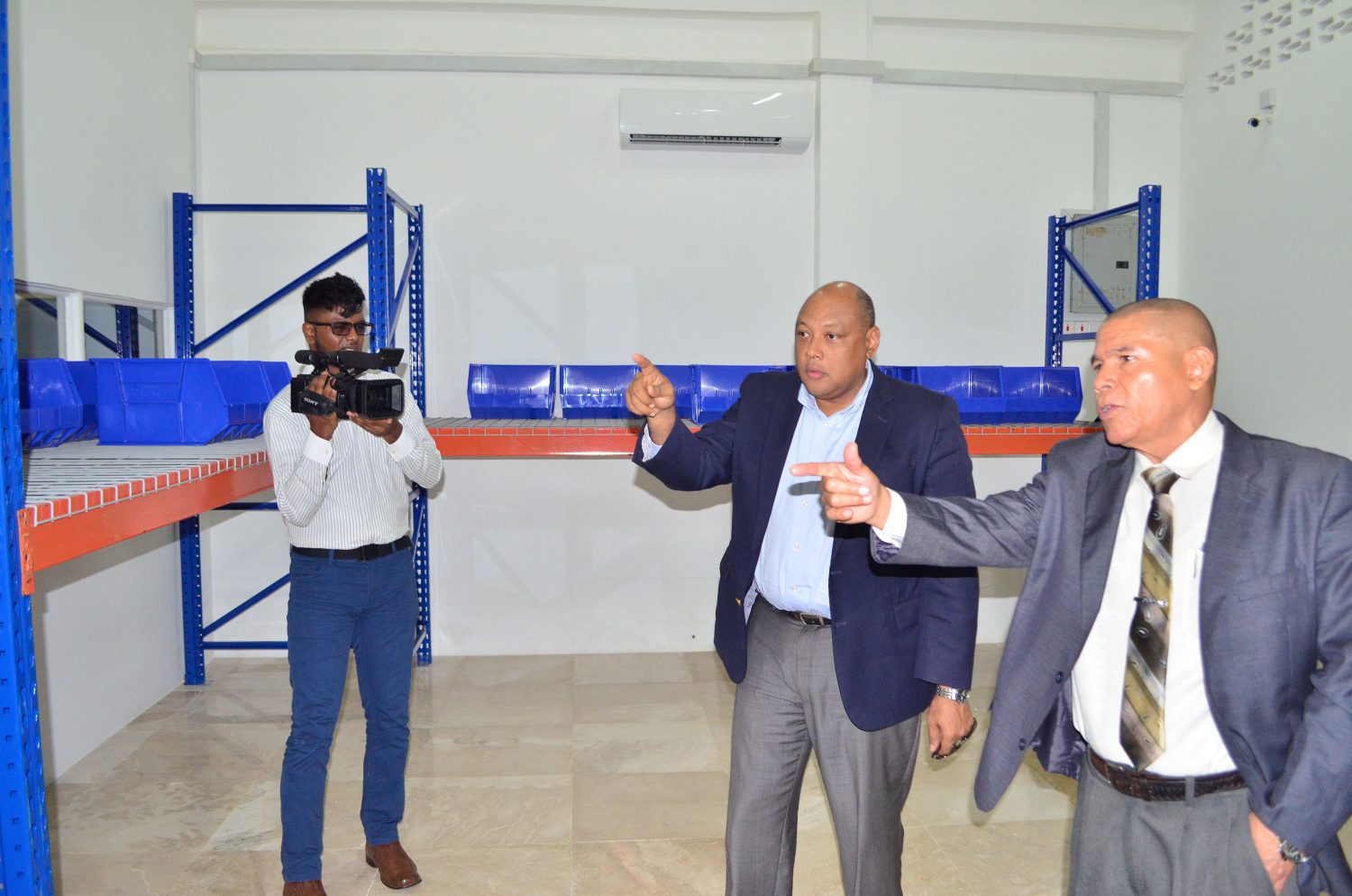 From right: Ministers George Norton and Raphael Trotman on a tour of the bond (SN file photo)