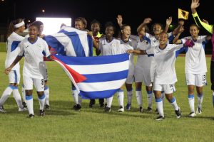 Flag Bearers-Members of the victorious Cuba team celebrating their crushing 8-0 win over Guyana in the CONCACAF Girls U17 Championship at the National Track and Field Centre, Leonora
