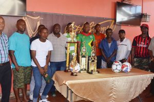 Three Peat Promotions representative Rawle Welch (left) with representatives of the competing teams, following the launch of the inaugural Guinness Cage Football Championship, at the Windjammer International Hotel (Orlando Charles photo) 