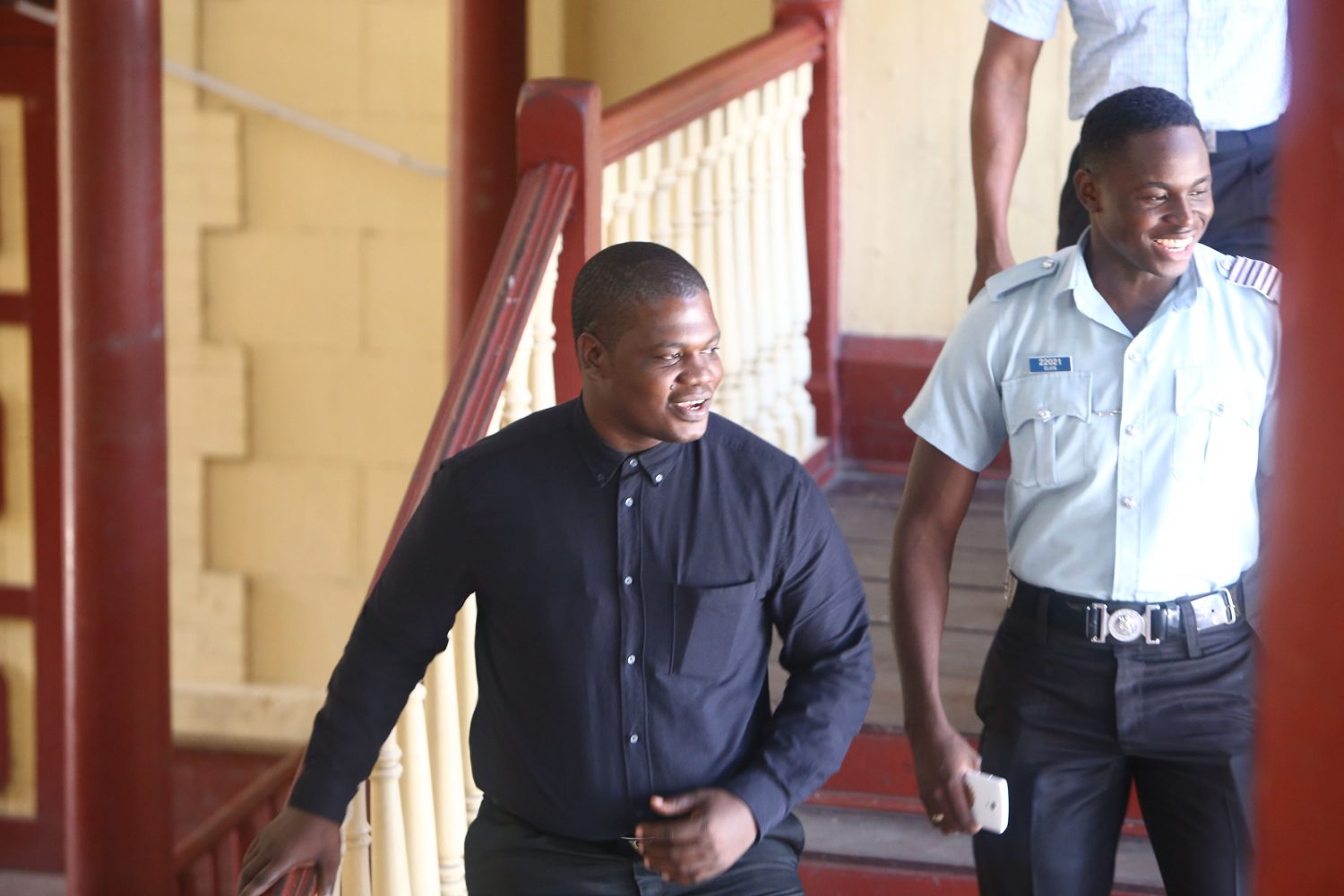 GDF rank Zamani Archibald (at left) as he proceeded down the court’s stairway, without handcuffs, in the company of an officer.
