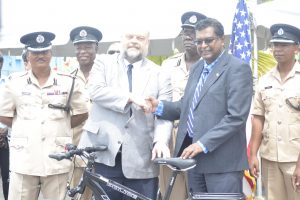 U.S Ambassador Perry Holloway (left) hands over the bicycles and accessories to Minister of Public Security Khemraj Ramjattan (DPI photo)