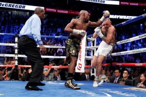 Floyd Mayweather Jr., on the attack  against Conor McGregor before referee Robert Byrd stops the fight. (Reuters photo)