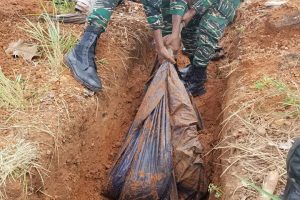 Soldiers removing the plastic lining from one of three dug-out trenches near the suspected illegal airstrip.  (GDF photo)
