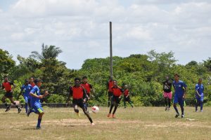 Action between Potaro Strikers (red) and Lazio (blue) on Thursday in the Bartica Zone of the Namilco U17 Football League