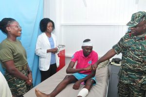Brian Samuels pounding the hand of army Chief of Staff Brigadier Patrick West, at the Medical Centre in Base Camp Ayanganna. (GDF photo) 